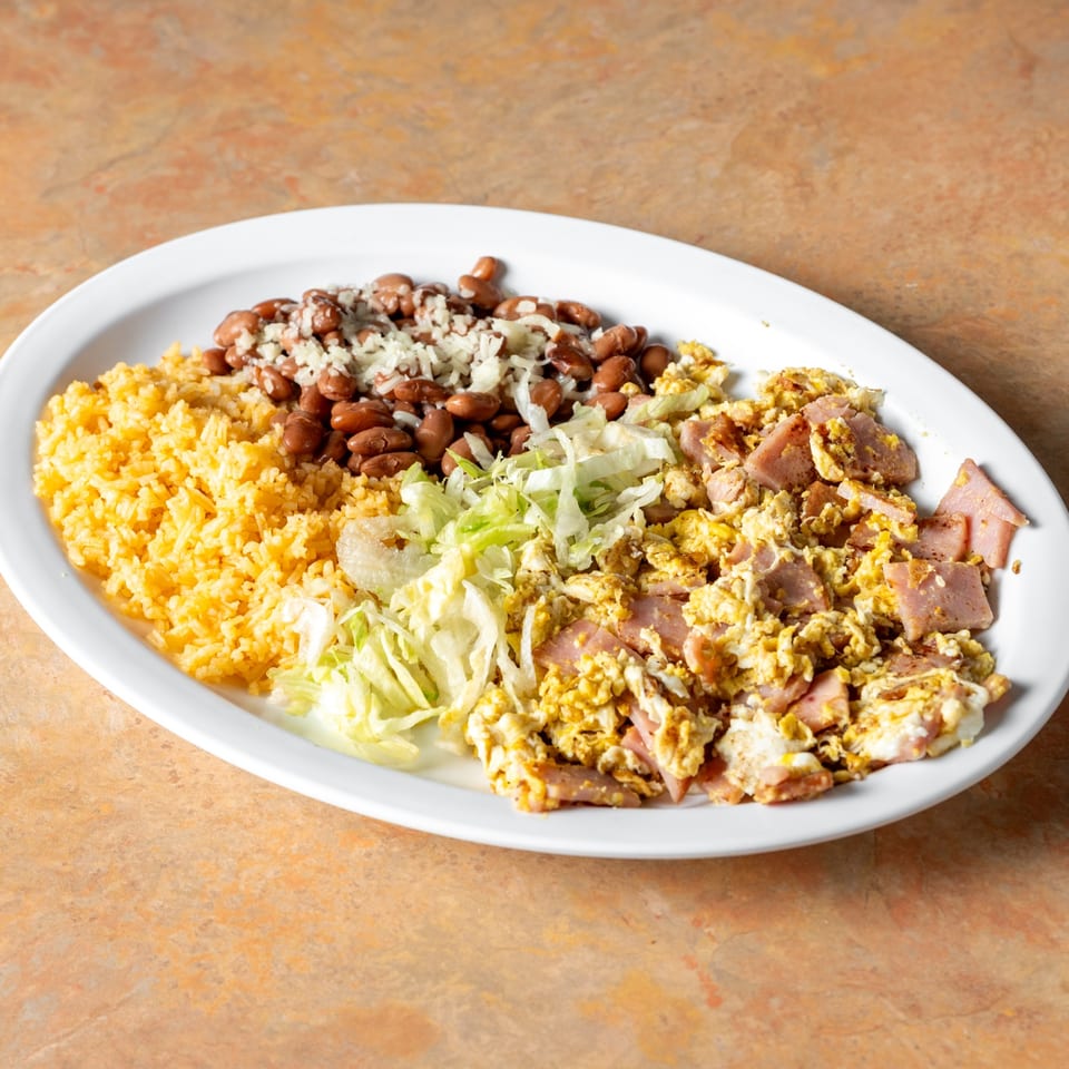 Ham and scrambled eggs with rice and beans.