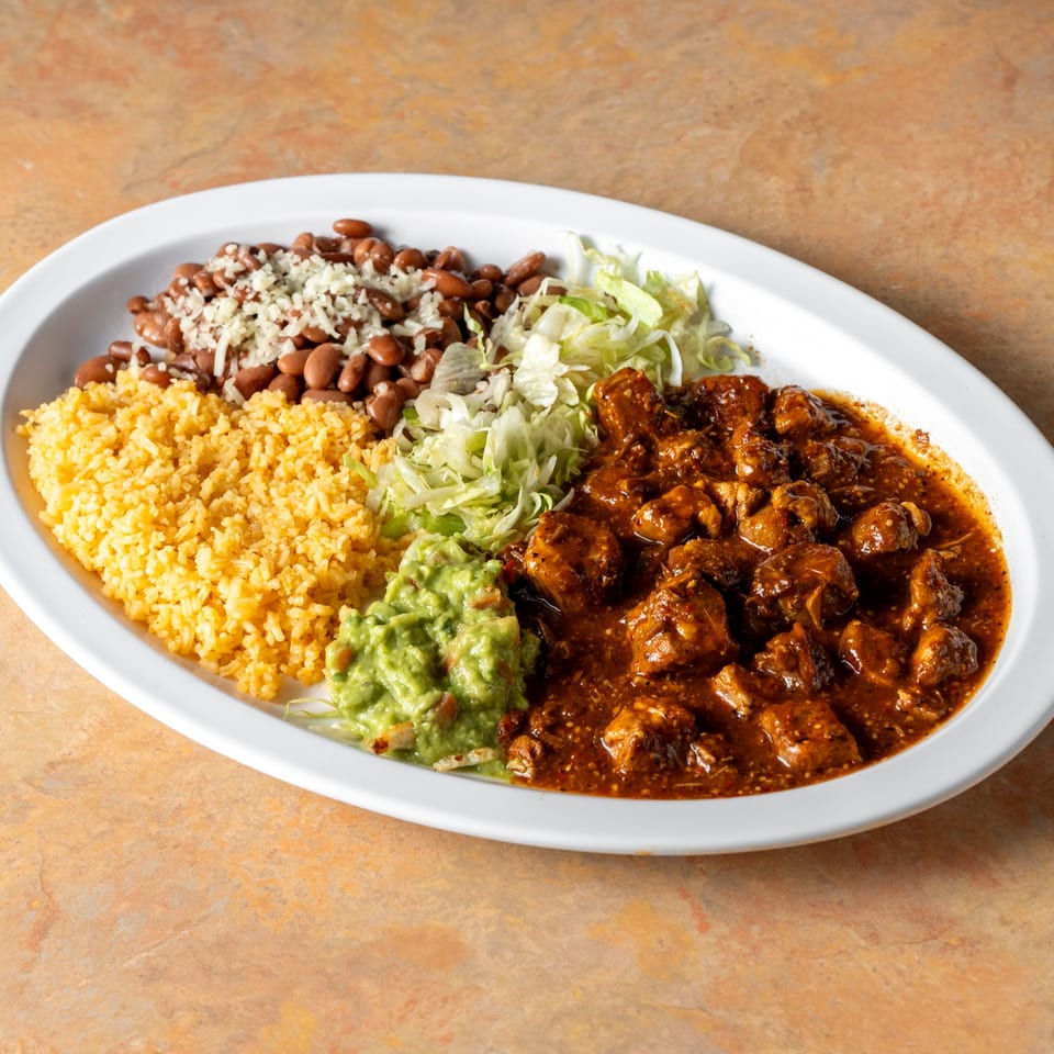 Meat in sauce with rice and beans.