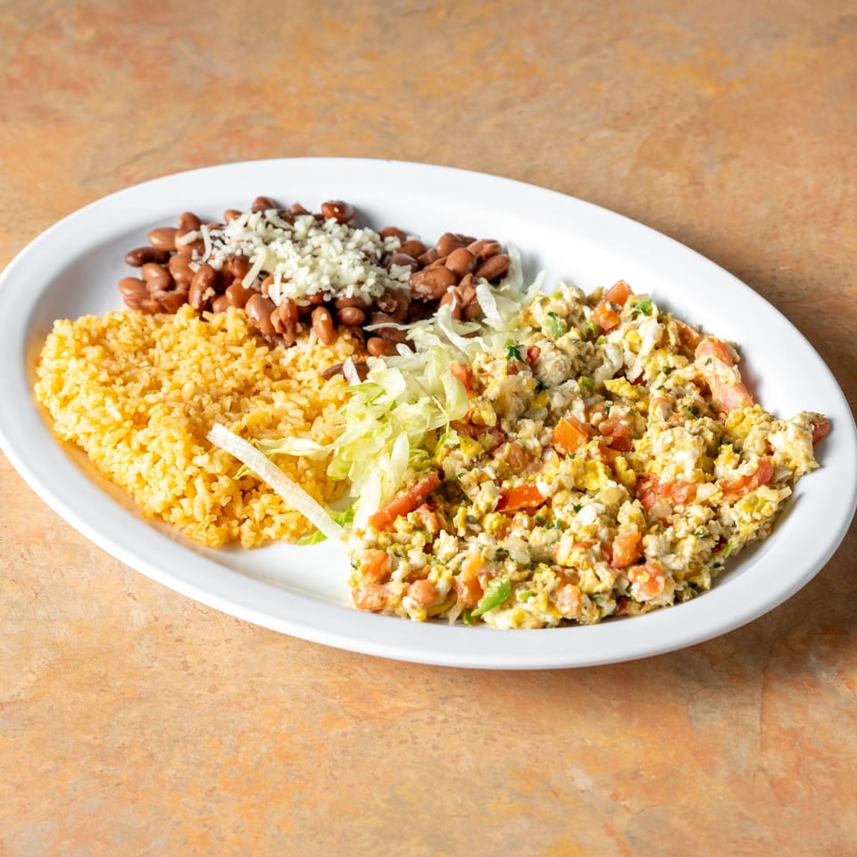 Scrambled eggs with vegetables, rice and beans.